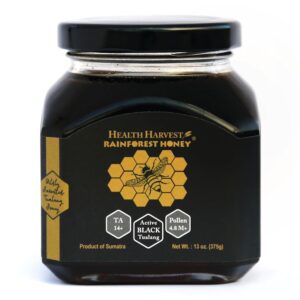 Jar of Health Harvest premium Black Tualang honey from Sumatra rainforest showing TA 14+ and high pollen count