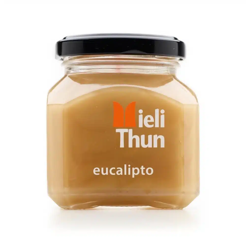 Glass jar of Meili Thun Eucalyptus Honey labeled “eucalipto,” with a black lid, on a white background.