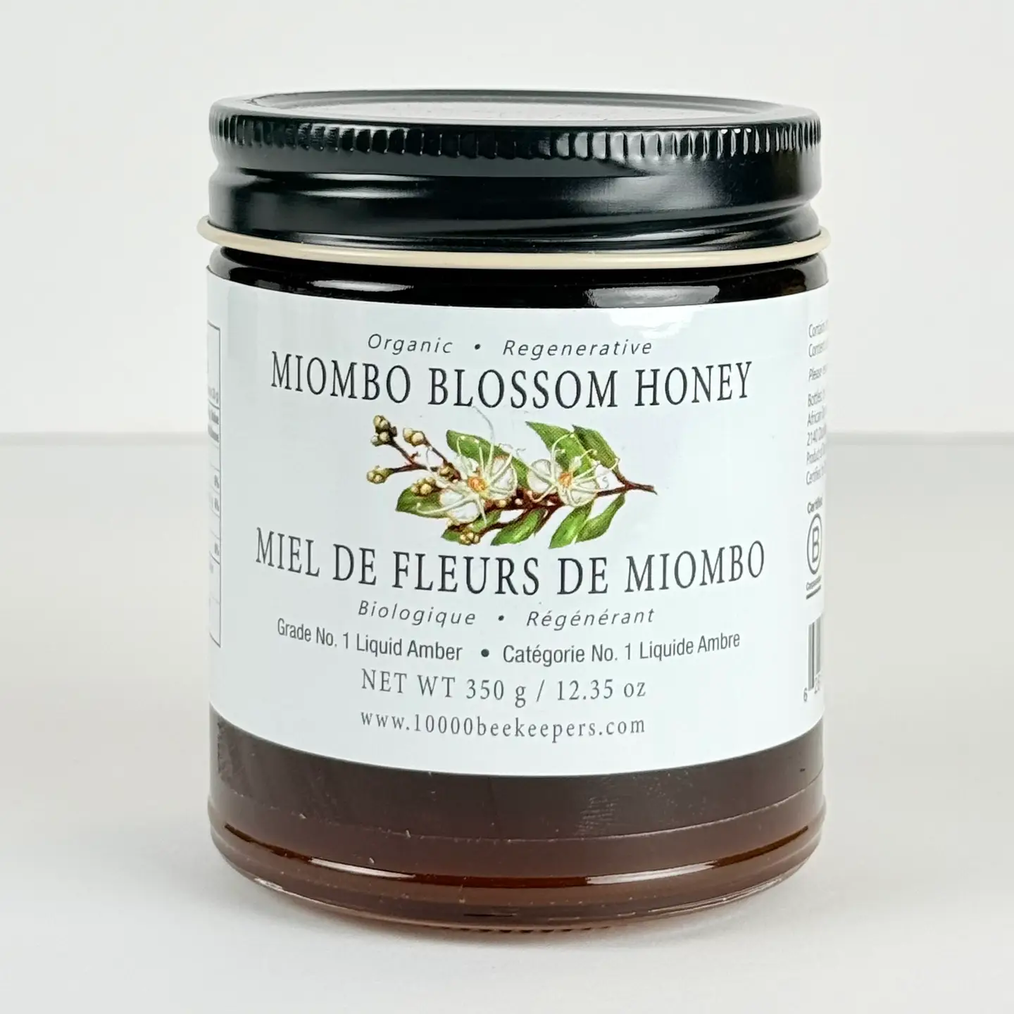 Front view of a 350 g jar of organic Miombo Blossom Honey