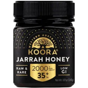 Front view of a 250 g jar of Koora Jarrah Honey TA35+ from Western Australia with a black and gold label.